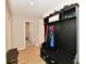 Welcoming mud room with a convenient hall tree storage unit and hardwood floors at 6398 Marden Trl, Brownsburg, IN 46112