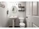 Bathroom features a pedestal sink, round mirror, and modern accents at 6559 Ambrosia Ln, Pendleton, IN 46064