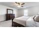 A well-lit bedroom boasts a dresser, window, ceiling fan and neutral color scheme at 6559 Ambrosia Ln, Pendleton, IN 46064