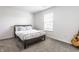 A comfortable bedroom featuring a bed, window, neutral color scheme, and guitar at 6559 Ambrosia Ln, Pendleton, IN 46064