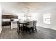 Bright dining area with modern chandelier, table with chairs and adjoining kitchen at 6559 Ambrosia Ln, Pendleton, IN 46064
