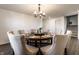 Elegant dining room with a round wood table seating eight and a modern chandelier at 6559 Ambrosia Ln, Pendleton, IN 46064