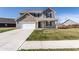 Two-story home with brick and gray siding, a two-car garage, and a well-manicured front lawn at 6559 Ambrosia Ln, Pendleton, IN 46064