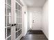 Clean, bright foyer with gray wood flooring, a decorative front door, and glass french doors at 6559 Ambrosia Ln, Pendleton, IN 46064
