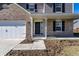 Front porch and door with brick and gray siding and trimmed front garden at 6559 Ambrosia Ln, Pendleton, IN 46064