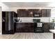 Well-lit kitchen with stainless steel refrigerator, microwave and range at 6559 Ambrosia Ln, Pendleton, IN 46064