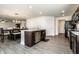 Open floor plan combining the kitchen with an island and stainless steel dishwasher at 6559 Ambrosia Ln, Pendleton, IN 46064