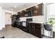 Modern kitchen with dark cabinetry, stainless steel appliances, and plenty of counter space at 6559 Ambrosia Ln, Pendleton, IN 46064