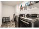 Modern laundry room with front-load washer and dryer and ample storage at 6559 Ambrosia Ln, Pendleton, IN 46064