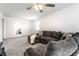 Open living room with sectional sofa, ceiling fan, and carpet at 6559 Ambrosia Ln, Pendleton, IN 46064
