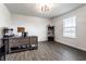 Bright, spacious home office with gray wood flooring, ample natural light, and a modern desk at 6559 Ambrosia Ln, Pendleton, IN 46064