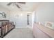 Neutral Bedroom boasts soft carpet, a crib, and a pink dresser at 657 Kilmore Dr, Pendleton, IN 46064