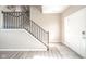 Bright entryway features wood-look flooring, a staircase with wood railings, and a white front door at 657 Kilmore Dr, Pendleton, IN 46064