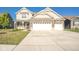 Inviting two-story home with brick accents and a spacious three-car garage and a manicured lawn at 657 Kilmore Dr, Pendleton, IN 46064