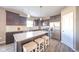 Bright kitchen with stainless steel appliances, dark cabinets, quartz countertops, and a center island at 657 Kilmore Dr, Pendleton, IN 46064