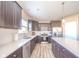Modern kitchen boasts stainless steel appliances, dark cabinets, and an island with white countertops at 657 Kilmore Dr, Pendleton, IN 46064