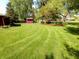 Green backyard showing lawn maintenance with storage shed on a sunny day at 7017 Mc Lain Dr, Indianapolis, IN 46217