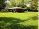 Well-maintained backyard with lush green lawn and landscaping surrounding a charming single-story home at 7017 Mc Lain Dr, Indianapolis, IN 46217