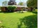 Spacious backyard showcasing a lush lawn, patio seating, and well-maintained landscaping, perfect for outdoor entertaining at 7017 Mc Lain Dr, Indianapolis, IN 46217