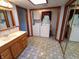 Bright bathroom with patterned floor tiles, a vanity with sink, and a washer/dryer at 7017 Mc Lain Dr, Indianapolis, IN 46217