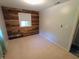 Bright bedroom boasts a natural wood accent wall and light-filled window at 7017 Mc Lain Dr, Indianapolis, IN 46217