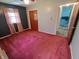 Bedroom featuring red carpet, a ceiling fan, a window with natural light, and a closet at 7017 Mc Lain Dr, Indianapolis, IN 46217