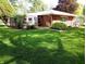 Classic brick home featuring neat landscaping, decorative accents, and a meticulously kept front yard at 7017 Mc Lain Dr, Indianapolis, IN 46217