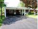 Covered parking and charming porch of a well-maintained brick home at 7017 Mc Lain Dr, Indianapolis, IN 46217