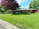 Charming brick ranch home features a covered parking and front porch at 7017 Mc Lain Dr, Indianapolis, IN 46217