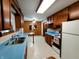 Kitchen with wood cabinets, blue countertops, tile floor, and stainless steel sink at 7017 Mc Lain Dr, Indianapolis, IN 46217