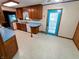 Functional kitchen features wood cabinets, blue counters, and vinyl flooring at 7017 Mc Lain Dr, Indianapolis, IN 46217