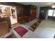 Living room featuring a dining nook, wood paneling, and access to the kitchen at 7017 Mc Lain Dr, Indianapolis, IN 46217