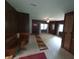 Living room with wood paneling, carpeted floor, and built-in dining nook at 7017 Mc Lain Dr, Indianapolis, IN 46217