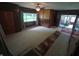 Open-concept living room with wood paneling and view to a sunroom at 7017 Mc Lain Dr, Indianapolis, IN 46217