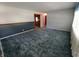 Spacious living room featuring plush carpeting and classic wainscoting detail at 7017 Mc Lain Dr, Indianapolis, IN 46217