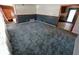 Open living area features plush carpeting and access to other rooms at 7017 Mc Lain Dr, Indianapolis, IN 46217