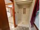 Modern walk-in shower featuring elegant tile work, a built-in niche, and sleek fixtures at 7017 Mc Lain Dr, Indianapolis, IN 46217