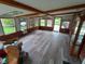 Bright sunroom with wood-beam ceiling and multiple windows showcasing the outdoors at 7017 Mc Lain Dr, Indianapolis, IN 46217