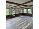 Spacious sunroom with wood-beam ceiling and multiple windows showcasing the outdoors at 7017 Mc Lain Dr, Indianapolis, IN 46217