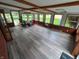 Bright sunroom featuring hardwood floors, wood trim, and lots of natural light from the large number of windows at 7017 Mc Lain Dr, Indianapolis, IN 46217