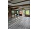 Sunroom featuring wood-beam ceiling, access to outdoors, and brick accents at 7017 Mc Lain Dr, Indianapolis, IN 46217
