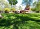 Brick ranch home surrounded by a large, meticulously maintained lawn and beautiful shade trees at 7017 Mc Lain Dr, Indianapolis, IN 46217