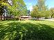 Large, verdant lawn and mature trees provide an idyllic setting for this charming brick home at 7017 Mc Lain Dr, Indianapolis, IN 46217