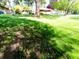 Lush lawn with mature trees partially shading the charming brick home and well-kept grounds at 7017 Mc Lain Dr, Indianapolis, IN 46217