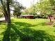 Lush yard with mature trees, enhancing curb appeal and creating a serene environment around the property at 7017 Mc Lain Dr, Indianapolis, IN 46217
