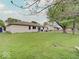 An expansive backyard features a patio and plenty of space for outdoor activities at 710 Marie Ln, Fortville, IN 46040