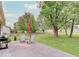 Enjoy a patio perfect for outdoor gatherings in this backyard with shade trees at 710 Marie Ln, Fortville, IN 46040