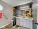 Updated bathroom featuring a modern vanity, stylish fixtures, and unique accent wall at 710 Marie Ln, Fortville, IN 46040