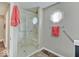 Bright bathroom featuring a glass shower with tiled walls and a unique octagonal window at 710 Marie Ln, Fortville, IN 46040