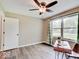 Bedroom featuring a ceiling fan and large window with a green gingham curtain at 710 Marie Ln, Fortville, IN 46040